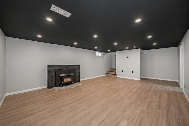 10413 E 6th Ave, Spokane Valley, WA 99206 - basement featuring light wood-style floors, stairway, recessed lighting, and a fireplace
