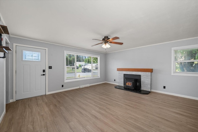 10413 E 6th Ave, Spokane Valley, WA 99206 - unfurnished living room featuring healthy amount of natural light, crown molding, light wood finished floors, and a ceiling fan