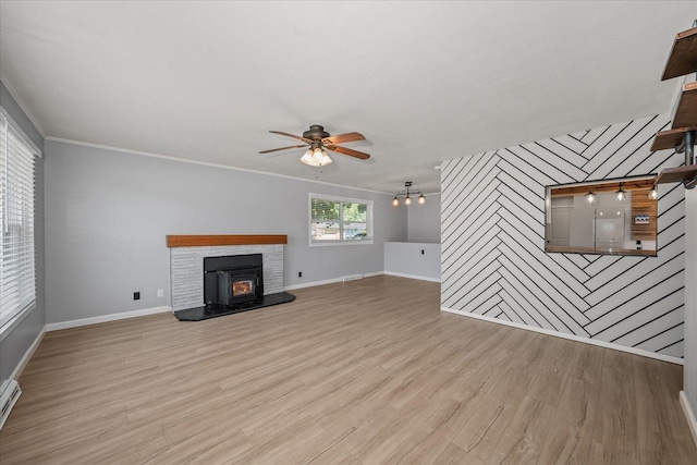 10413 E 6th Ave, Spokane Valley, WA 99206 - unfurnished living room with ceiling fan, wood finished floors, crown molding, an accent wall, and a chandelier