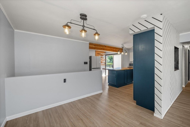 10413 E 6th Ave, Spokane Valley, WA 99206 - kitchen with blue cabinets, light wood finished floors, freestanding refrigerator, a chandelier, and crown molding