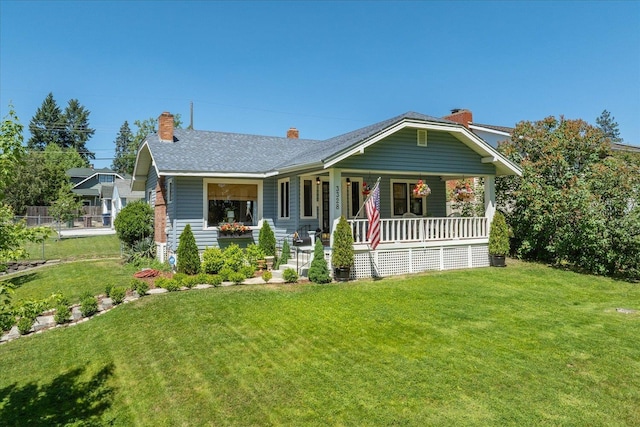 3328 W Kiernan Ave, Spokane, WA 99205 - view of front facade with a porch, a front yard, and a chimney