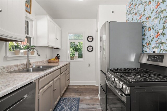 3328 W Kiernan Ave, Spokane, WA 99205 - kitchen with stainless steel appliances, dark wood-style flooring, light countertops, and white cabinetry