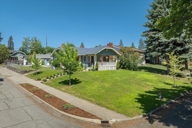 3328 W Kiernan Ave, Spokane, WA 99205 - view of front of property with covered porch, a front yard, and a chimney