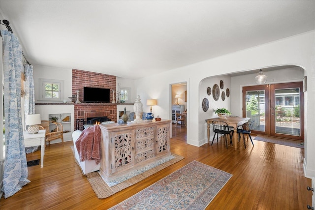 3328 W Kiernan Ave, Spokane, WA 99205 - living area with arched walkways, plenty of natural light, wood finished floors, and a fireplace
