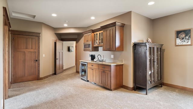 21617 E Harvard Vistas Ln, Newman Lake, WA 99025 - kitchen featuring wine cooler, light colored carpet, stainless steel microwave, brown cabinetry, and recessed lighting