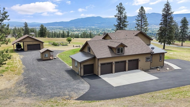 21617 E Harvard Vistas Ln, Newman Lake, WA 99025 - view of front facade featuring a garage, a mountain view, driveway, and roof with shingles