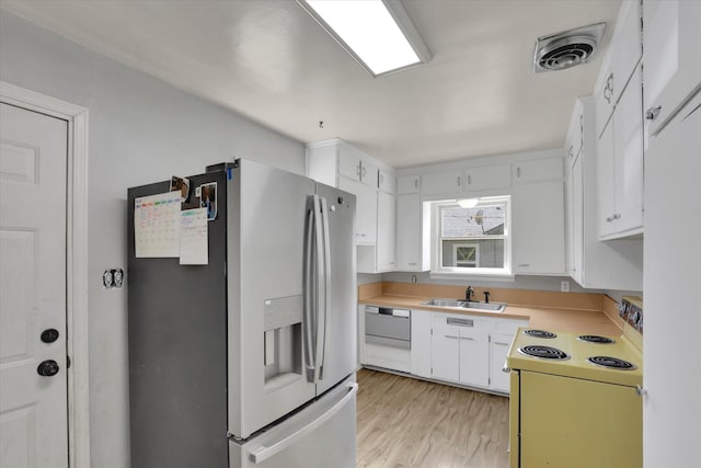 314 E Everett Ave, Spokane, WA 99207 - kitchen featuring white appliances, white cabinetry, light wood-style floors, and light countertops