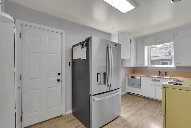 314 E Everett Ave, Spokane, WA 99207 - kitchen featuring white appliances, light wood-style floors, white cabinets, and light countertops