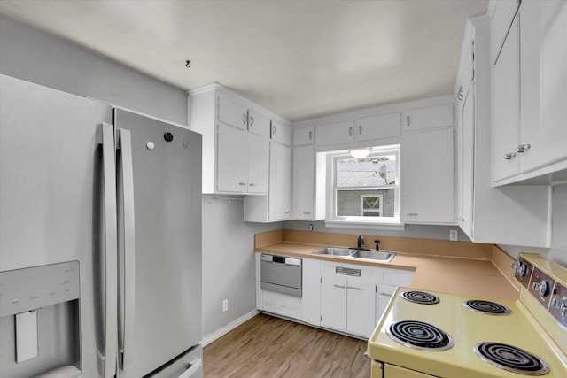 314 E Everett Ave, Spokane, WA 99207 - kitchen with electric stove, stainless steel refrigerator with ice dispenser, dishwasher, light wood-style floors, and light countertops