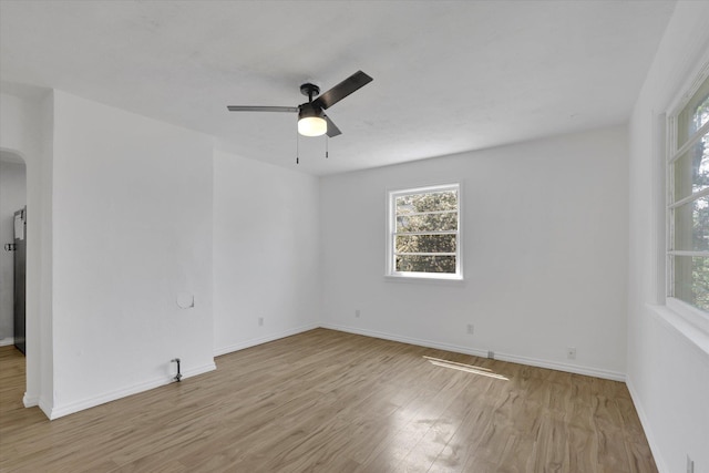 314 E Everett Ave, Spokane, WA 99207 - spare room with wood finished floors, arched walkways, and a ceiling fan