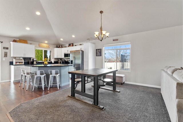 9805 N Jesse Ct, Spokane, WA 99208 - dining space with a chandelier, vaulted ceiling, recessed lighting, and dark wood-type flooring