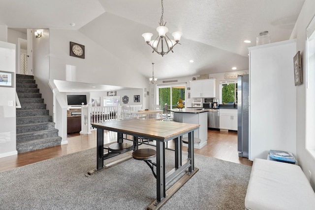 9805 N Jesse Ct, Spokane, WA 99208 - dining area with a chandelier, lofted ceiling, wood finished floors, stairs, and recessed lighting