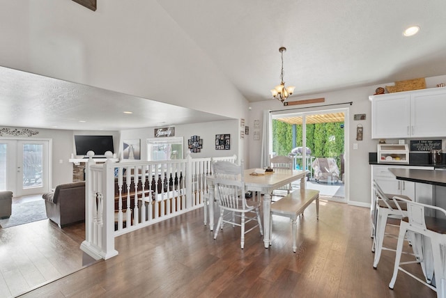 9805 N Jesse Ct, Spokane, WA 99208 - dining area featuring a chandelier, plenty of natural light, wood finished floors, vaulted ceiling, and a textured ceiling