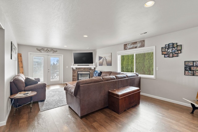 9805 N Jesse Ct, Spokane, WA 99208 - living room with wood-type flooring, healthy amount of natural light, a fireplace, a textured ceiling, and recessed lighting
