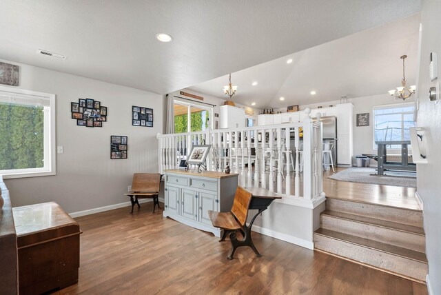 9805 N Jesse Ct, Spokane, WA 99208 - staircase with a chandelier, wood finished floors, healthy amount of natural light, vaulted ceiling, and recessed lighting