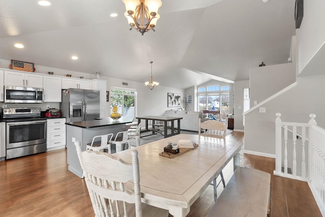 9805 N Jesse Ct, Spokane, WA 99208 - dining room with a chandelier, lofted ceiling, wood finished floors, and recessed lighting