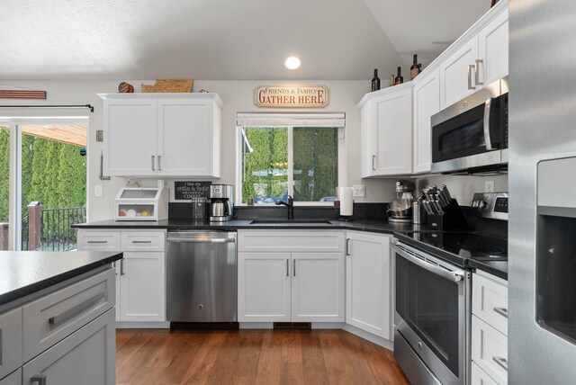 9805 N Jesse Ct, Spokane, WA 99208 - kitchen with appliances with stainless steel finishes, white cabinetry, plenty of natural light, dark countertops, and recessed lighting