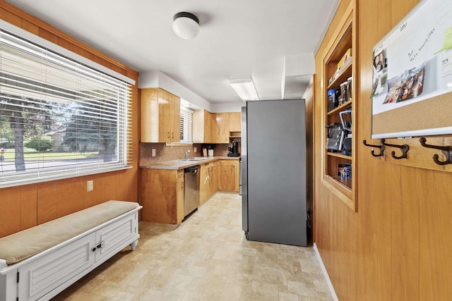 2620 S Pines Rd, Spokane Valley, WA 99206 - kitchen with appliances with stainless steel finishes, light countertops, tasteful backsplash, and wooden walls