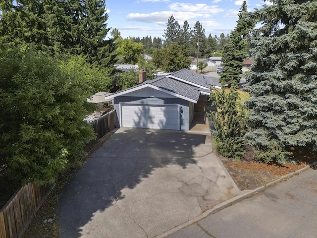 2620 S Pines Rd, Spokane Valley, WA 99206 - view of front of home featuring a chimney, driveway, an attached garage, and roof with shingles