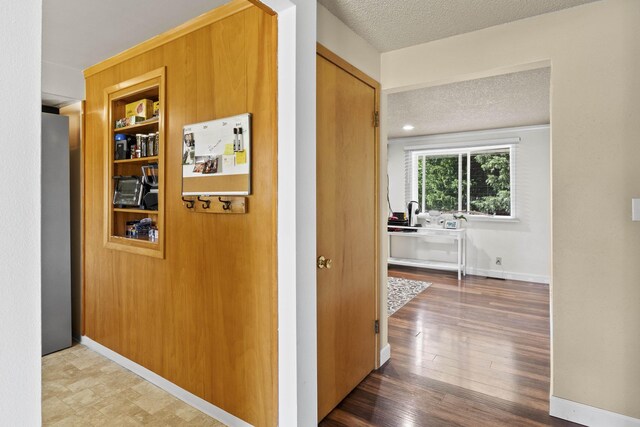2620 S Pines Rd, Spokane Valley, WA 99206 - corridor with a textured ceiling and wood finished floors
