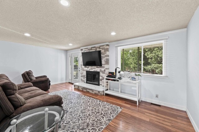 2620 S Pines Rd, Spokane Valley, WA 99206 - living area with a textured ceiling, wood finished floors, recessed lighting, and a fireplace