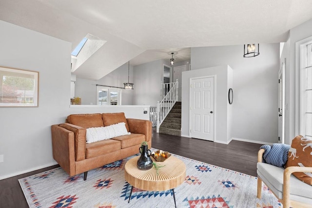 8805 N Greenwood St, Spokane, WA 99208 - living area with wood finished floors, vaulted ceiling, a chandelier, stairway, and a skylight