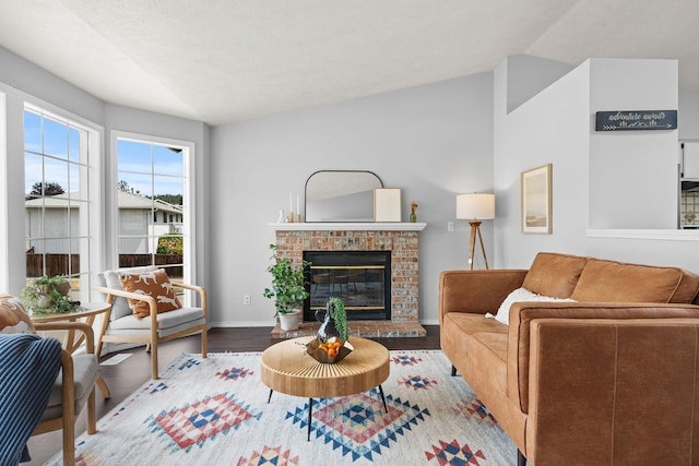 8805 N Greenwood St, Spokane, WA 99208 - living area with vaulted ceiling, a fireplace, and wood finished floors