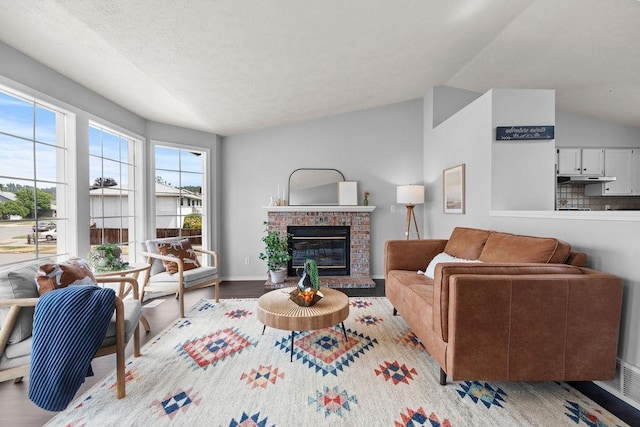 8805 N Greenwood St, Spokane, WA 99208 - living room with a fireplace, wood finished floors, and lofted ceiling