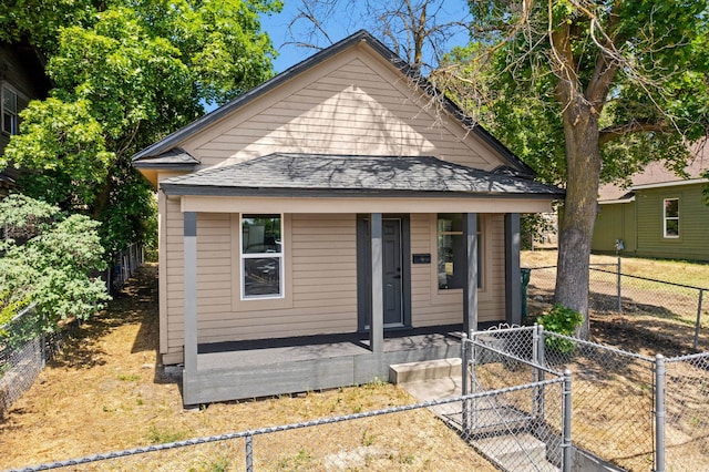 1608 W Maxwell Ave, Spokane, WA 99201 - shotgun-style home with covered porch, a gate, and roof with shingles