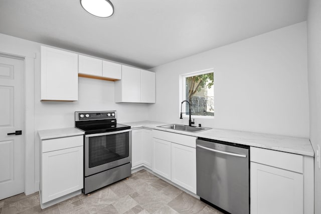 1608 W Maxwell Ave, Spokane, WA 99201 - kitchen featuring appliances with stainless steel finishes, white cabinetry, and light stone countertops