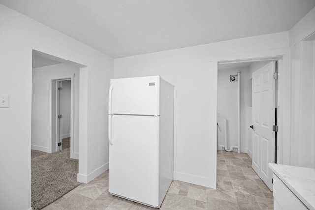1608 W Maxwell Ave, Spokane, WA 99201 - kitchen featuring freestanding refrigerator and light stone countertops
