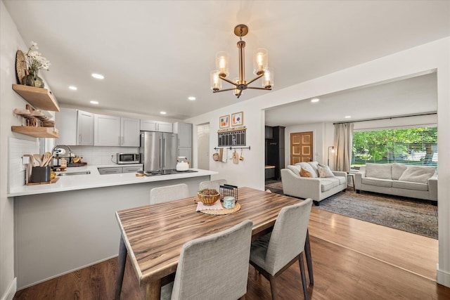 2804 E 39th Ave, Spokane, WA 99223 - dining room featuring a chandelier, recessed lighting, and dark wood-type flooring
