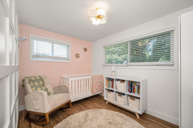 2804 E 39th Ave, Spokane, WA 99223 - bedroom featuring wood finished floors and a nursery area