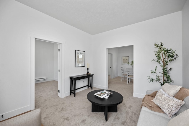 1509 N Maple St, Spokane, WA 99201 - carpeted living area featuring a baseboard heating unit and baseboards