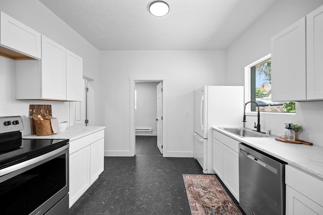1509 N Maple St, Spokane, WA 99201 - kitchen featuring stainless steel appliances, dark flooring, light countertops, white cabinets, and baseboard heating