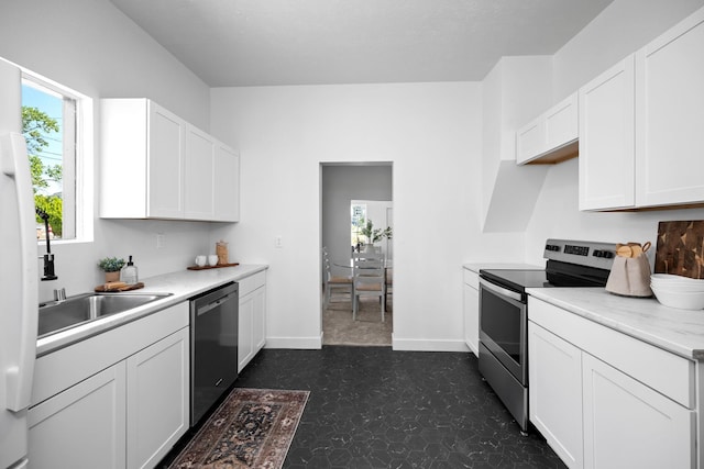 1509 N Maple St, Spokane, WA 99201 - kitchen featuring stainless steel appliances, dark flooring, light countertops, and white cabinetry