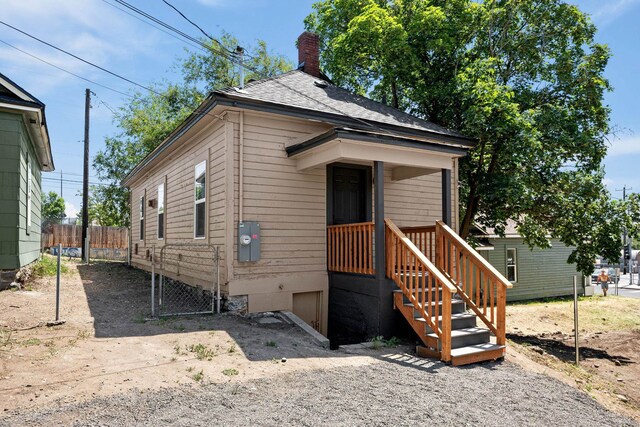 1507 N Maple St, Spokane, WA 99201 - shotgun-style home featuring a chimney and a shingled roof