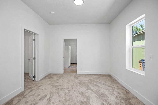 1507 N Maple St, Spokane, WA 99201 - unfurnished bedroom with freestanding refrigerator and carpet flooring