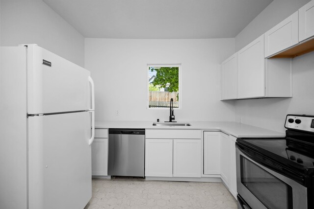 1604 W Maxwell Ave, Spokane, WA 99201 - kitchen featuring appliances with stainless steel finishes, white cabinetry, and light countertops