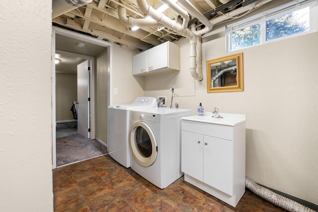 10021 N Whittier St, Spokane, WA 99218 - laundry area featuring cabinet space, washing machine and dryer, and dark stone finish floors