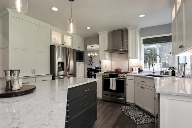 5522 E Cargill Ln, Colbert, WA 99005 - kitchen featuring appliances with stainless steel finishes, wall chimney range hood, white cabinetry, tasteful backsplash, and light stone countertops