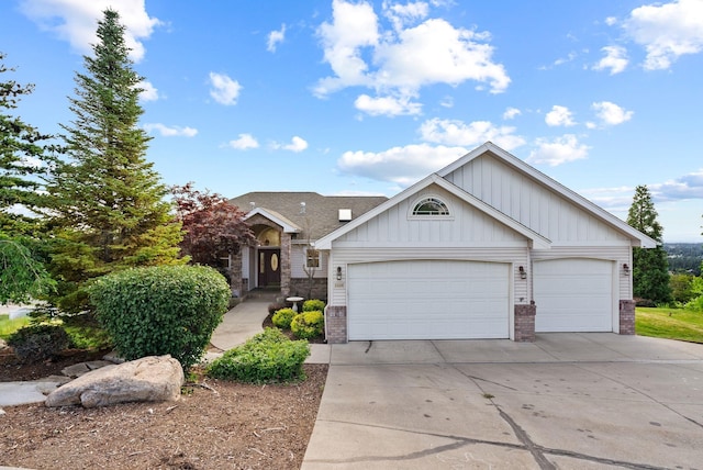 5506 S Southview Ln, Spokane, WA 99223 - view of front of house with brick siding, concrete driveway, an attached garage, and board and batten siding