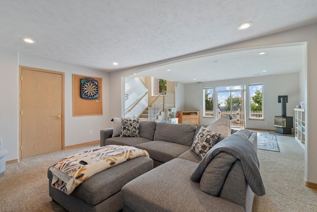 5506 S Southview Ln, Spokane, WA 99223 - living area with light colored carpet, a wood stove, stairway, recessed lighting, and arched walkways