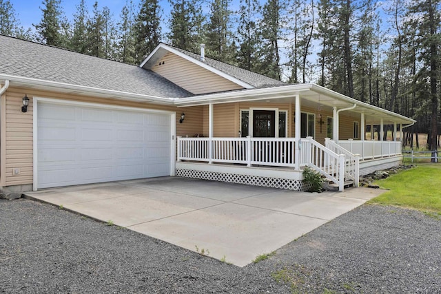 7905 W Seven Mile Rd, Nine Mile Falls, WA 99026 - view of front facade with covered porch, a shingled roof, a garage, and driveway