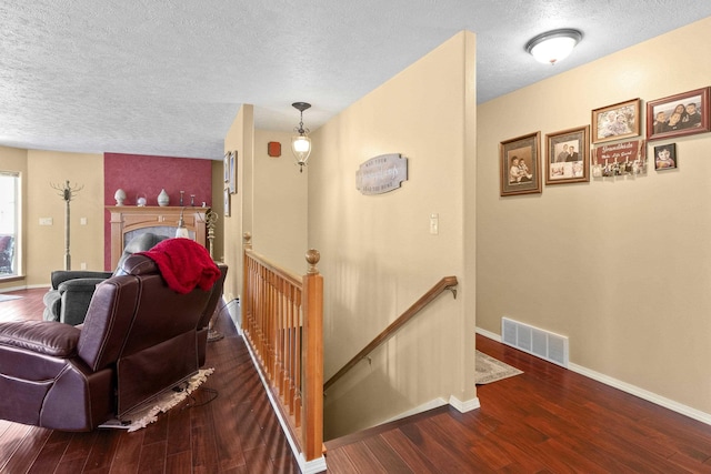 7905 W Seven Mile Rd, Nine Mile Falls, WA 99026 - hall featuring an upstairs landing, a textured ceiling, and wood finished floors