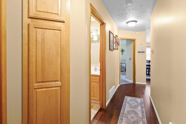 7905 W Seven Mile Rd, Nine Mile Falls, WA 99026 - hall with a textured ceiling and dark wood finished floors