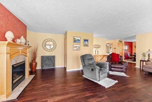 7905 W Seven Mile Rd, Nine Mile Falls, WA 99026 - living area featuring a textured ceiling, wood finished floors, and a fireplace
