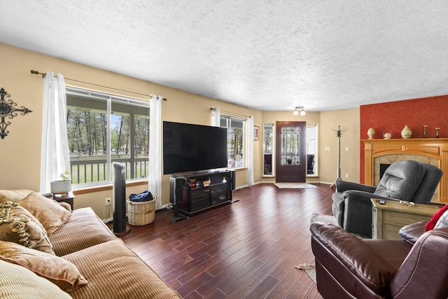 7905 W Seven Mile Rd, Nine Mile Falls, WA 99026 - living area featuring a fireplace, a textured ceiling, and wood finished floors