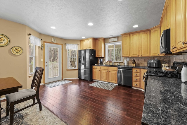 7905 W Seven Mile Rd, Nine Mile Falls, WA 99026 - kitchen featuring black appliances, decorative backsplash, dark wood finished floors, dark stone countertops, and recessed lighting