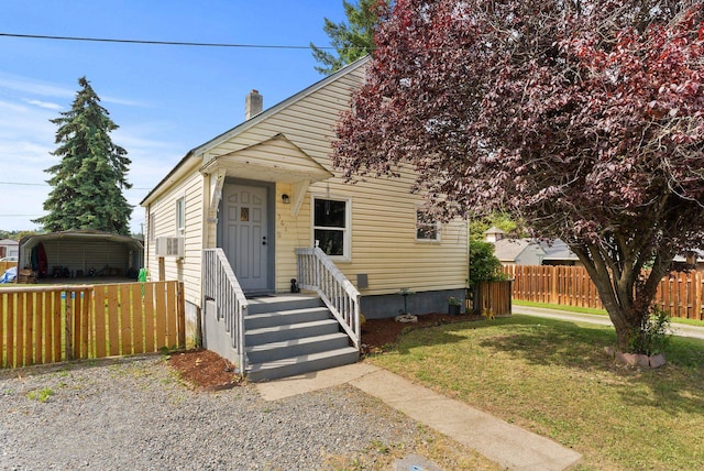 561 E Forest Ave, Colville, WA 99114 - view of front facade featuring a carport, cooling unit, and a chimney